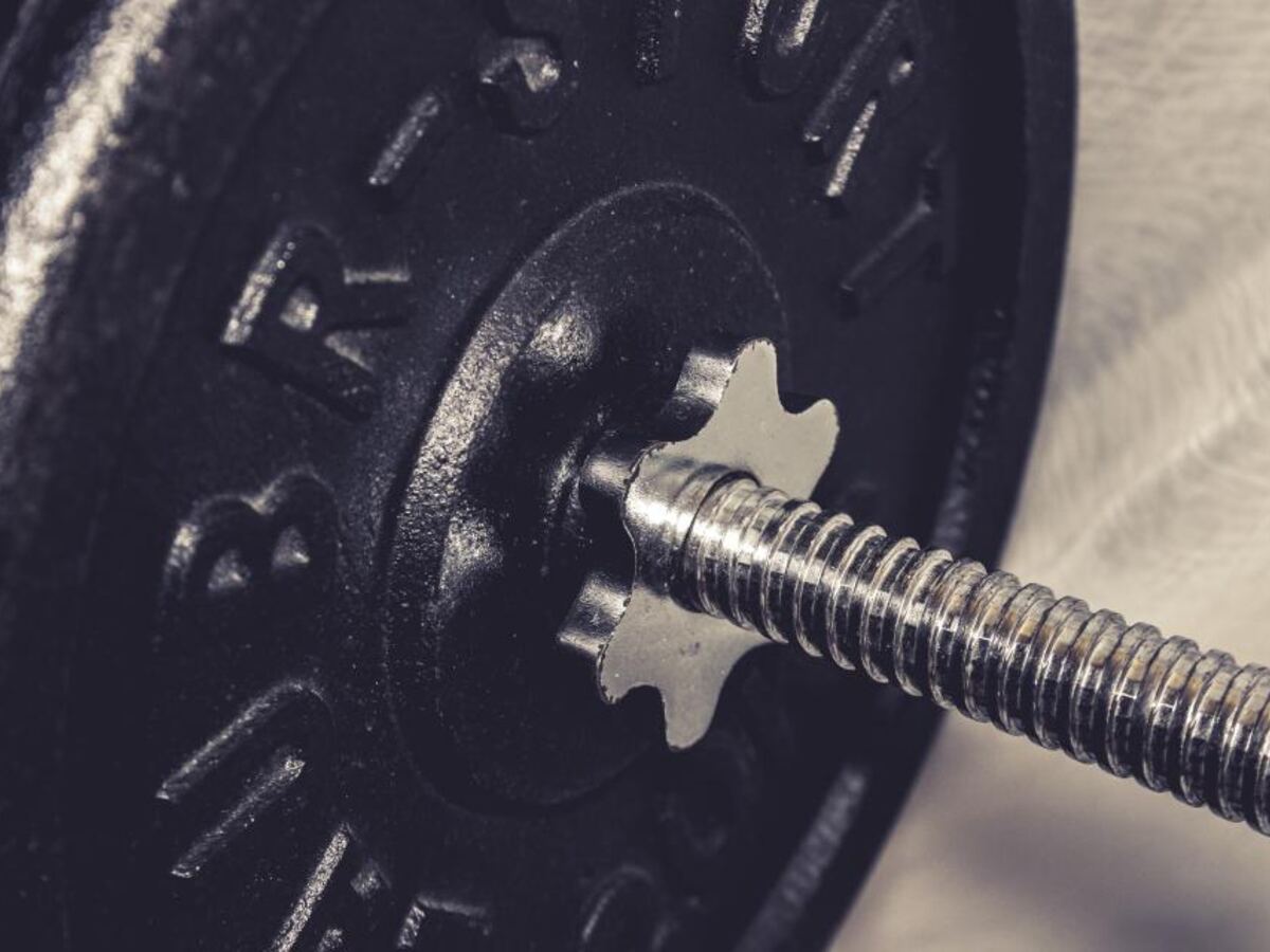 Close-up of a loaded barbell weight plate in a gym
