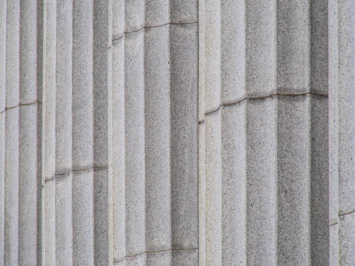 Close-up of classical stone columns on a courthouse-style building